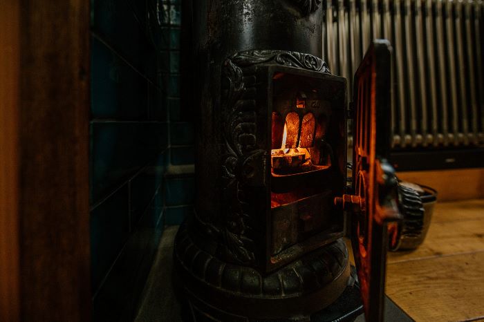 Cosy interior of a luxury Boutique Narrowboat with glowing stove