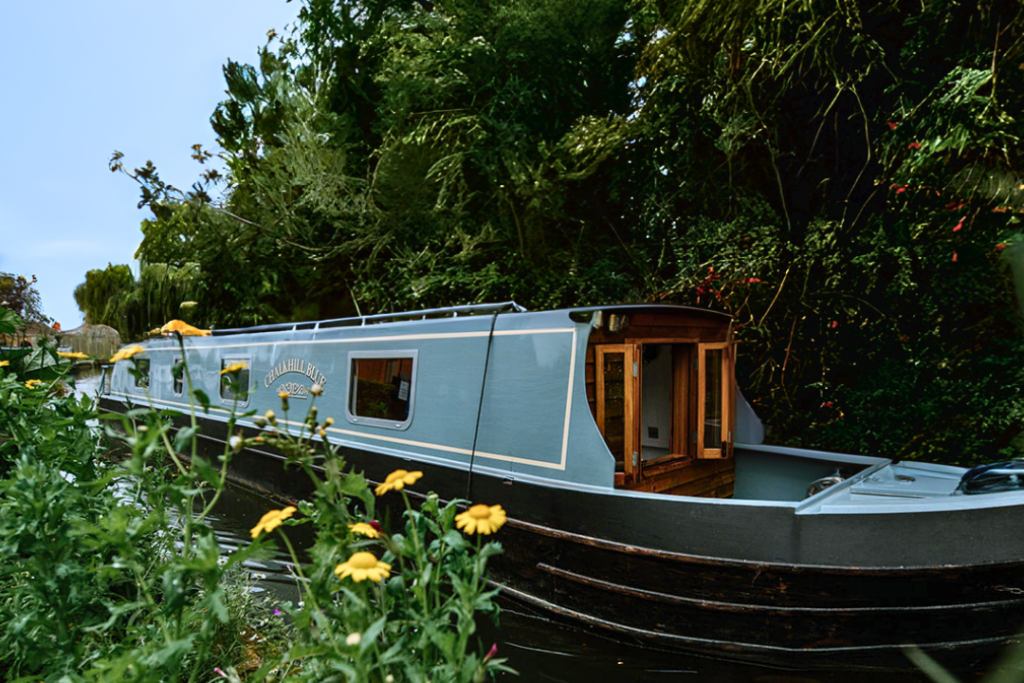 Luxury narrowboat holiday cruising slowly through peaceful countryside